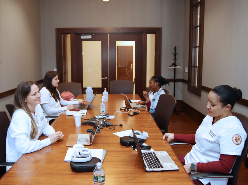 group of female nursing students around table at thomas edison state university