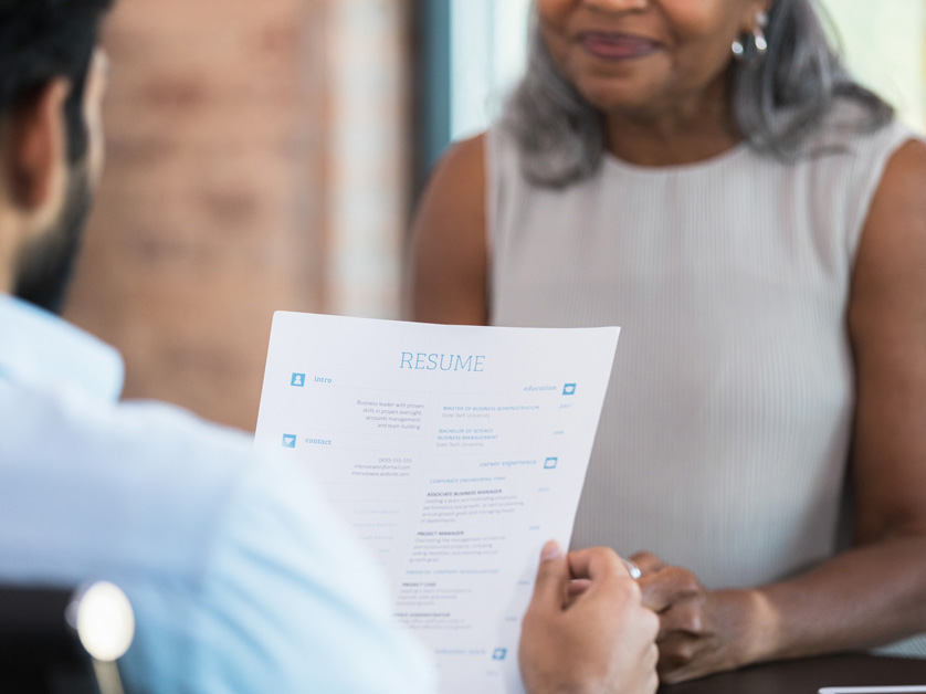 woman having a resume reviewed