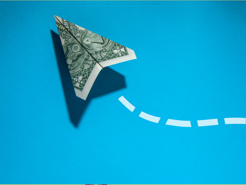 paper dollar money airplane on blue background