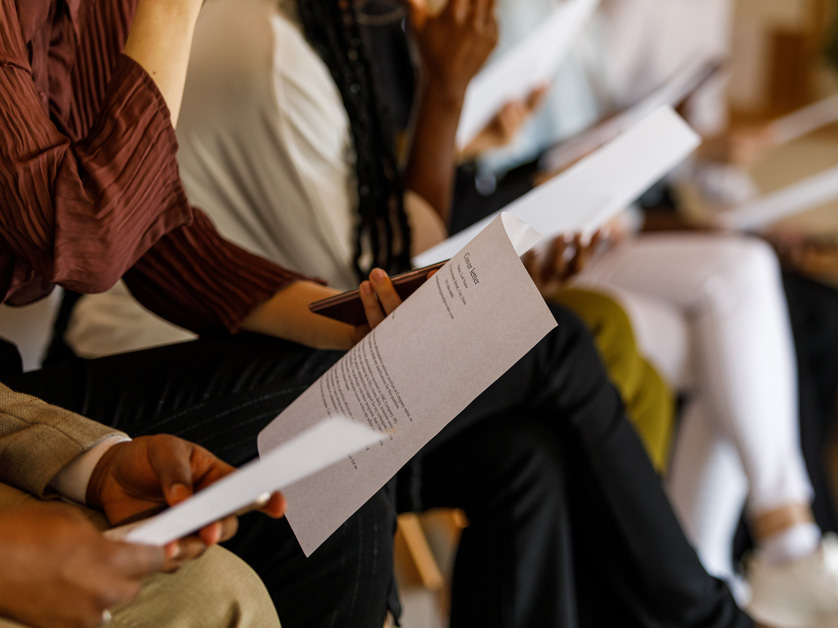 close up of people holding cover letters