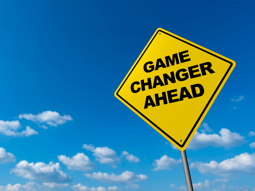 yellow sign on blue sky says game changer ahead
