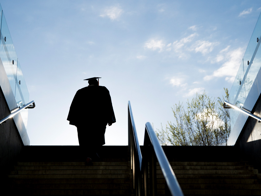 silhouette of graduate climbing stairs
