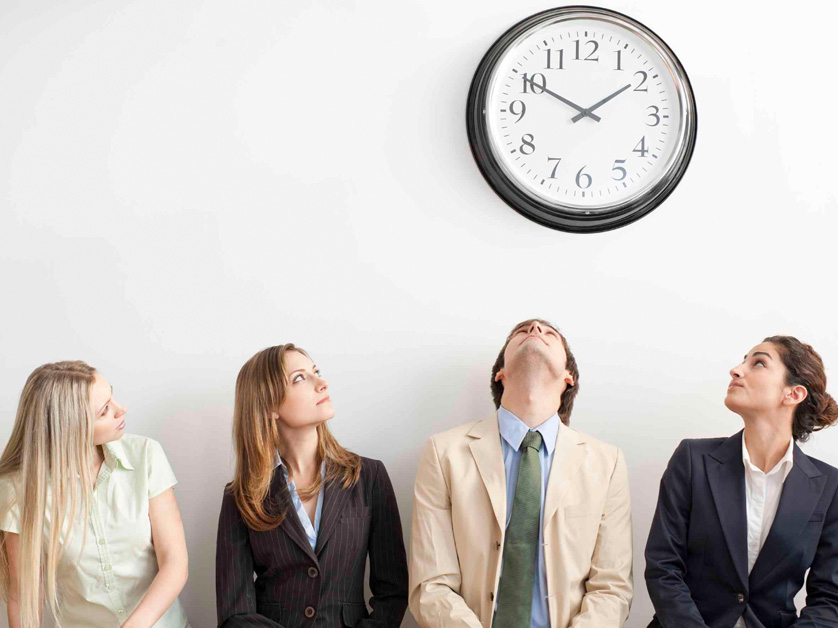 people staring up at a clock on the wall