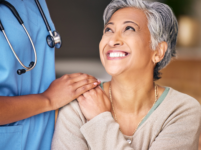 senior woman smiling at nurse
