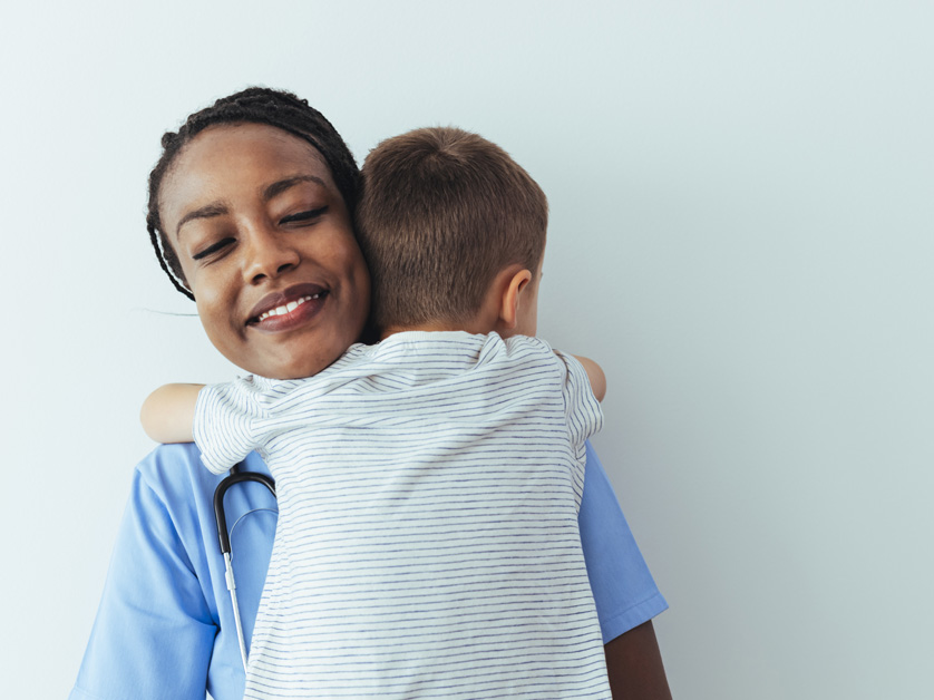 woman hugging young boy