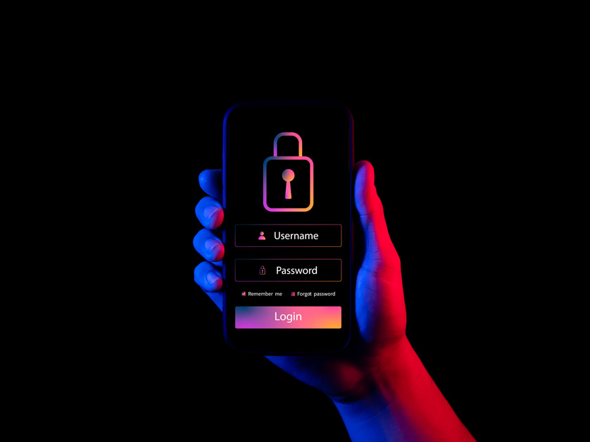 hand holding phone with security features in dark