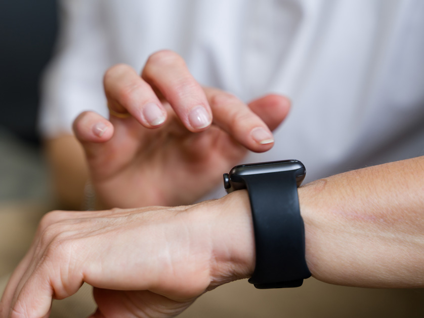close up of woman tapping on wrist watch