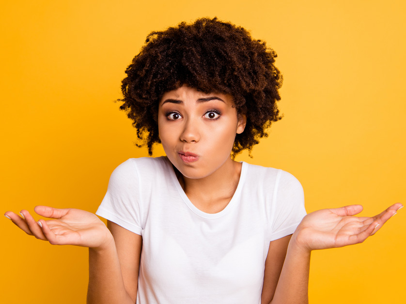 woman confused on yellow background