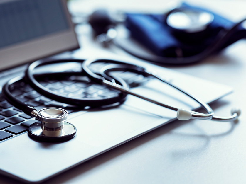 laptop computer with stethoscope on it