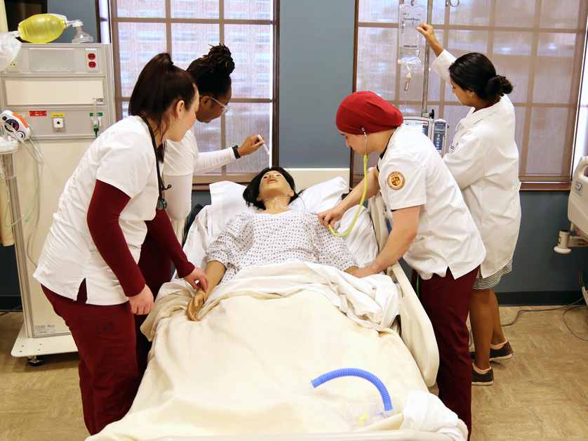 group of nursing students at bedside of patient
