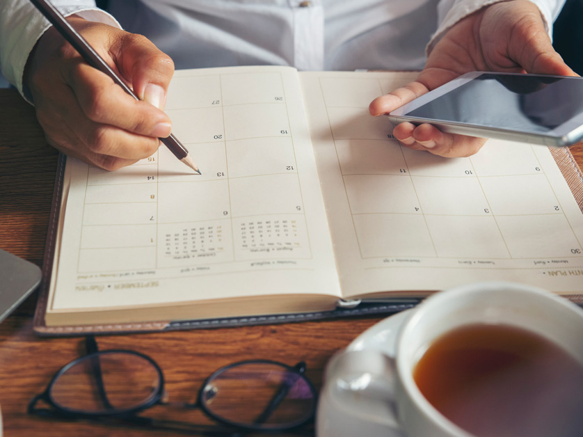 woman writing in a calendar