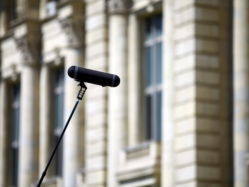 microphone in front of blurred city hall