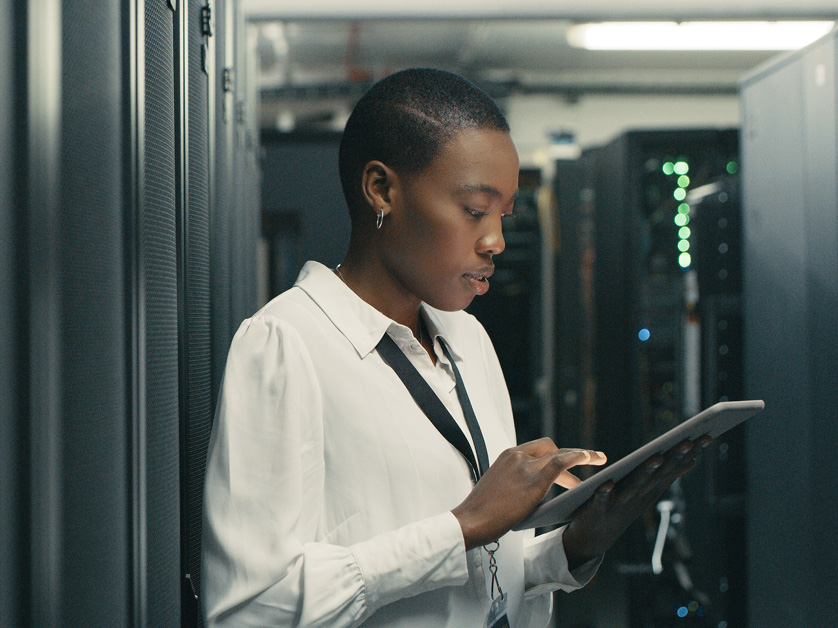 woman in data room typing on tablet