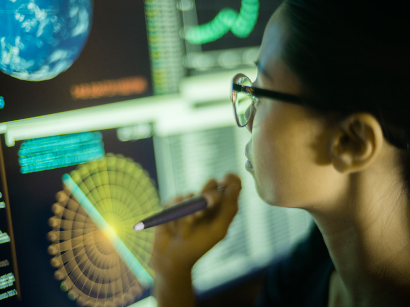 woman in front of computer code