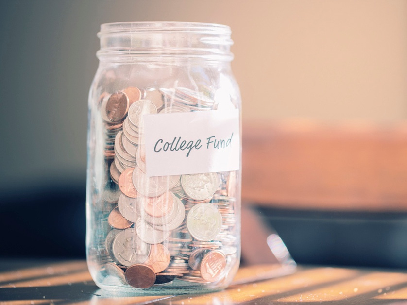 college fund sign on mason jar filled with change