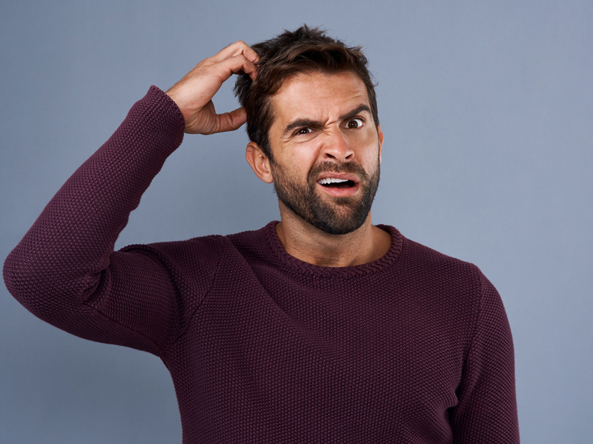 man scratching his head confused