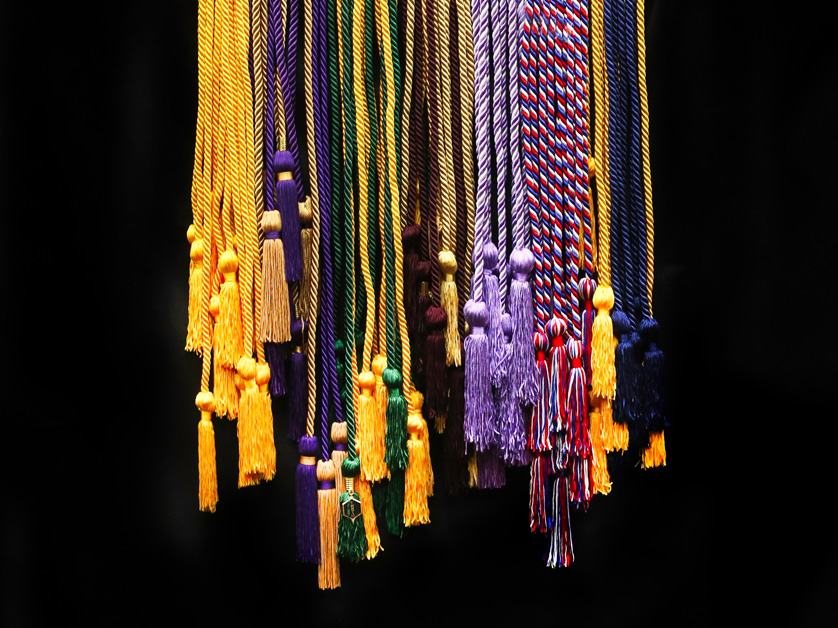 stack of commencement honor cords on black